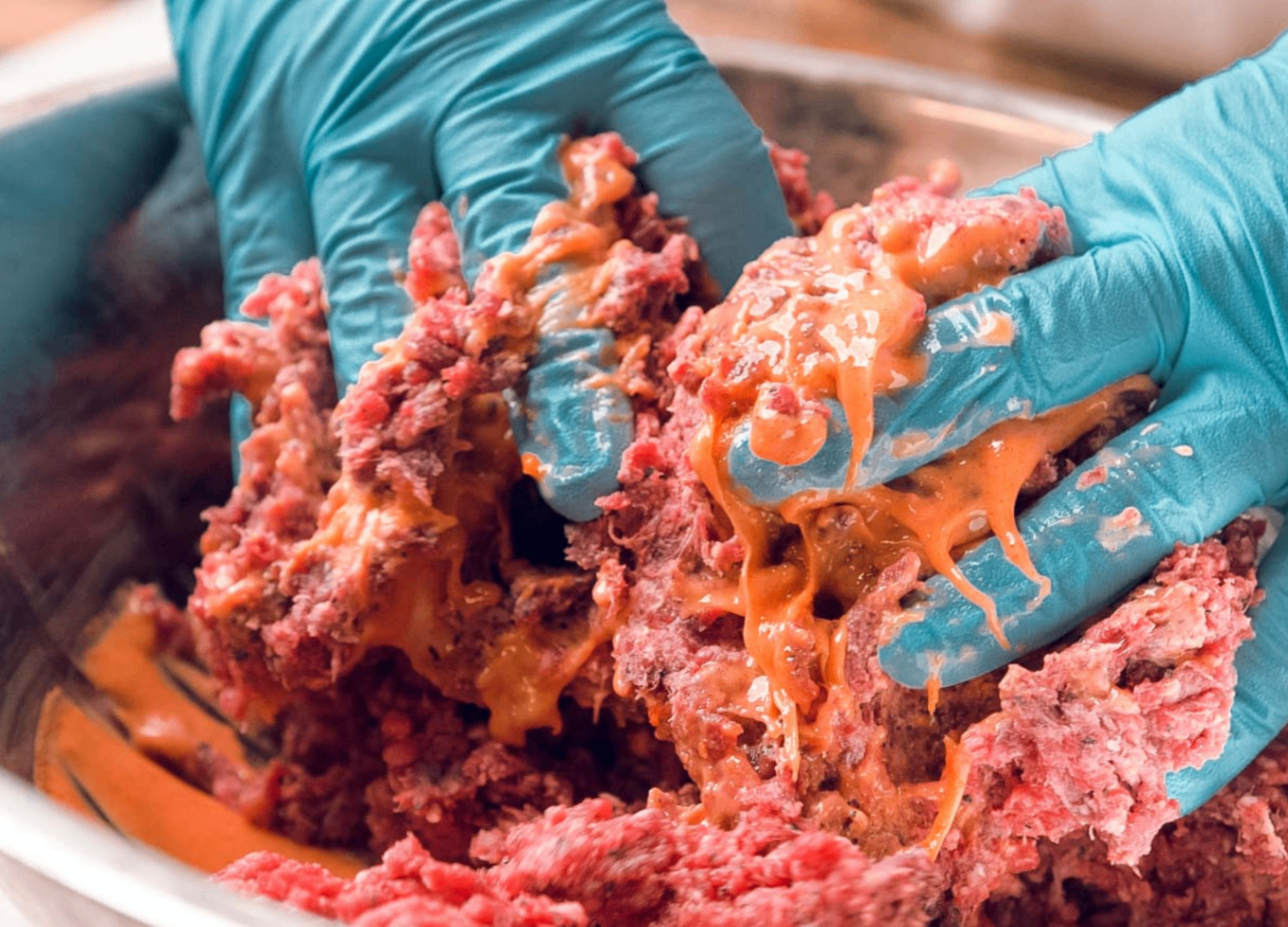 Hands mixing a fresh batch of ingredients by hand