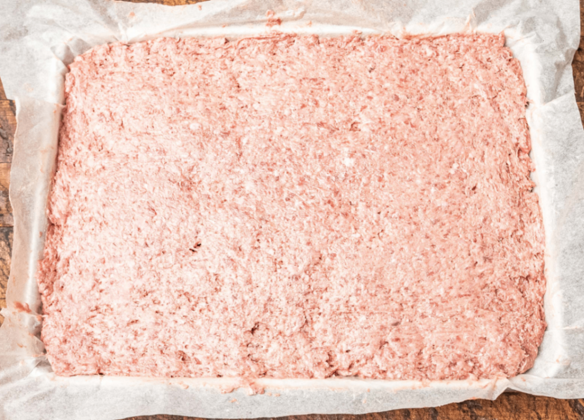 A full tray of evenly pressed treat mixture ready to bake